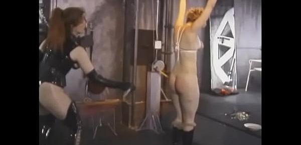  Big booty redhead domina gives a hard spanking to naughty blonde in the basement